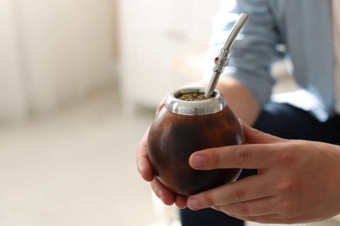man with traditional yerba mate tea